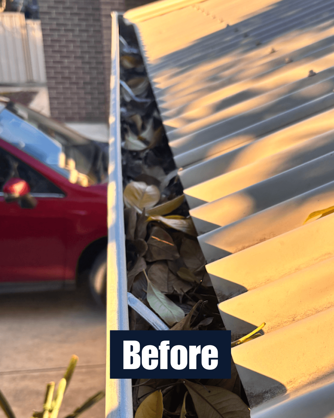 Blocked gutter before cleaning with leaf build-up