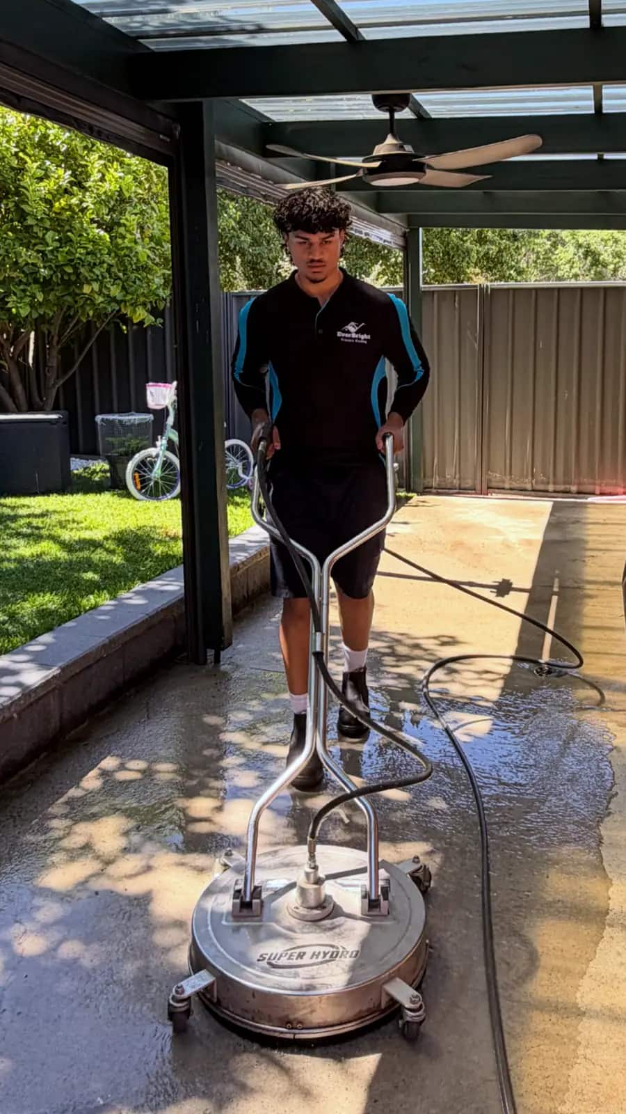 Pressure washing a brick driveway