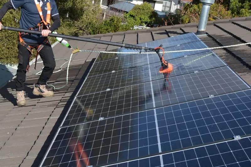 Cleaning solar panels on a sunny day